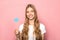 KYIV, UKRAINE - JUNE 7, 2019: woman holding Twitter sign isolated on pink