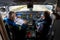 Kyiv, Ukraine - November 25, 2020: Embraer aircraft cockpit. Pilots in medical masks. Technicians diagnose, repair and service the