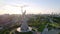 Kyiv, Ukraine - September, 2021: aerial view of Motherland Monument. Drone footage with sun flares. Monumental statue in