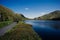 Kylemore Lough lake at Connemara National Park under a blue sky on a sunny day