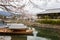 Kyoto, Japan, 04/06/2017: Traditional wooden Japanese boats on the river in a beautiful flowering spring nature. Holiday Hanami