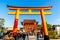 Kyoto, Japan - Jan 11, 2020 : Red Torii gates at Fushimi Inari Taisha with tourists and Japanese students. Fushimi Inari is the