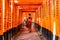 Kyoto, Japan - Jan 11, 2020 : Red Torii gates at Fushimi Inari Taisha with tourists and Japanese students. Fushimi Inari is the