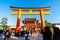 Kyoto, Japan - Jan 11, 2020 : Red Torii gates at Fushimi Inari Taisha with tourists and Japanese students. Fushimi Inari is the