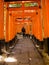 KYOTO, JAPAN - JULY 05, 2017: Unidentified man posing for camera at Red Tori Gate at Fushimi Inari Shrine in Kyoto