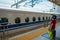 KYOTO, JAPAN - JULY 05, 2017: Unidentified woman admiring the JR700 shinkansen bullet train departing Kyoto station