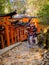 KYOTO, JAPAN - JULY 05, 2017: Unidentified woman posing for camera at Red Tori Gate at Fushimi Inari Shrine in Kyoto