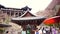 Kyoto, Japan - March 2015: The large ancient wood structure of Kiyomizu-dera (Kiyomizu Temple) view from bottom with red umbrella,