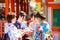 Kyoto, Japan - March 28, 2015 : Japanese woman in Kimono reading O-mikuji fortune prediction strips of paper at Fushimi Inari S