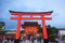 Kyoto, Japan - Nov 11 2017 : Pathway with red ancient wood torii gate and tourists walking at Fushimi Inari