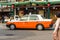 KYOTO, JAPAN - NOVEMBER 7, 2017: Orange taxi on the city street. Copy space for text.