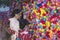 KYOTO, JAPAN - NOVEMBER, 8, 2019: Japanese Geisha Signing Colorful Temple Charm Formed as Colorful Squishy Balls And Made of Cloth