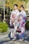 KYOTO, JAPAN - NOVEMBER, 8, 2019: Two Young Asian Girls Posing in Geisha Kimono in Traditional Japanese Environment in Kyoto,