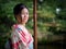 Kyoto, Japan - October 03: Unidentified female tourist in tradional Japanese clothes smiles in Shoren-In temple on