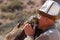 Kyrgyz hunter or Berkutchi hugging a golden eagle, Kyrgyzstan.