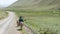 Kyrgyz kid riding a donkey through the countryside