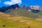 Kyrgyzstan. Mountain landscape with herd of horses and mobile home