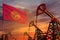 Kyrgyzstan oil industry concept. Industrial illustration - Kyrgyzstan flag and oil wells with the red and blue sunset or sunrise