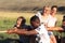 Kyzyl, Russia - August 14, 2015: a group of teenagers play active games in nature and pull a rope with emotions on their faces.