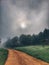 L calm landscape with road in misty gray winters day