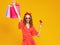 l funny girl  with plastic credit card for shopping for yellow color background