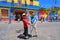 La Boca, Buenos Aires, Asian tourists dancing tango in front of colorful painted houses.