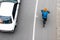 La Calera, Colombia - October, 2020: Overhead shot of  a cyclist being overtaken by a car on the road between Bogota and La Calera