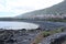 La Caleta beach with volcanic black sand under the mountain. Caleta de Interian, Tenerife, Spain