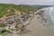 La Entrada, Ecuador - September 14, 2018 - Drone aeiral view of colorful coastal town from the beach.