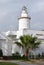 La Farola lighthouse in Malaga, an old coastal building in the harbour, Spain