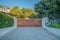 La Jolla, California- Entrance of a private residence with concrete driveway and large wooden gate