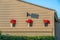 La Jolla, California- Three poinsettia plants on a concrete wall below the wall light