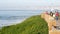 La Jolla, San Diego, CA USA -24 JAN 2020: Group of people walking on steep high cliff promenade, multiethnic pedestrians, tourists