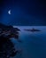 La Pelosa beach, Stintino, Sardegna, dreamy surreal night with starry sky and giant bright moon