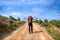 La Rioja, Spain - A Pilgrim on a Countryside Road acoss Rioja Vineyards along the Way of St James Camino de Santiago