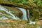 La Vaioaga waterfall logg stone rocks moss flowing water