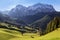 La Vale Valley - Italian Dolomites, a small village in the mountains, right next to a high forest stands a slender church. In the