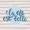 La vie est belle - hand drawn French lettering phrase it means Life is beautiful on striped grunge background