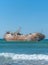 Laayoune port, Morocco, Western Sahara - January 6, 2019: a rusty ship was wrecked in the Ocean. Copy space. Vertical