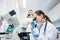 Lab assistant and veterinarian examining tissues sample from a cat