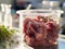 Lab-Grown Meat. Meat sample in glass cup for cell culture in laboratory. Concept of cultivating pure meat in vitro. Synthetic meat