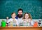 In lab. Small girls holding test tubes in school laboratory. Little pupils and teacher doing laboratory research