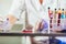 Lab technician assistant analyzing a blood sample in test tube at laboratory.