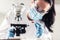 Lab technician examines a blood sample during research efforts for vaccine and drug invention against the novel coronavirus