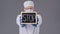 Lab technician in protective mask holding tablet with stop sign in hands