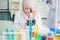 Lab worker Positive muslim woman looking into the microscope while being at work in the lab