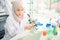 Lab worker Positive muslim woman looking into the microscope while being at work in the lab