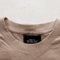 Label and collar of a cotton  beige stylish men`s shirt on the white background. Fashionable details of a casual look. Stylish