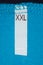 Label size XXL on blue cloth.
