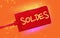 Label with SOLDES sales in French text on it. Orange Background.